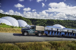 Land Rover Electric Defender at the Eden Project in Cornwall, towing visitor carriages