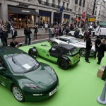 Regent Street Motor Show, a Delta Electric Car in the foreground sits quietly beside a Caterham and Aston Martin