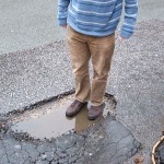 CTC's Chris Peck standing in the pothole