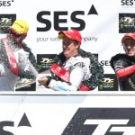 Bruce Anstey, John McGuinness and Lee Johnston spray the champagne on the podium for the SES TT Zero Challenge trophy | Credit Stephen Davison/Pacemaker Press Intl.
